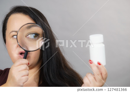 Woman investigating ingredients of medicines Woman investigating ingredients of medicines 127481366