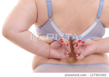 Woman back view putting on her bra lingerie. Woman back view putting on her bra lingerie. 127481402
