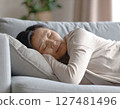 Senior woman lying down due to menopausal physical condition 127481496