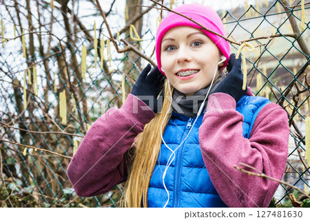 Woman wearing sportswear exercising outside during autumn 127481630