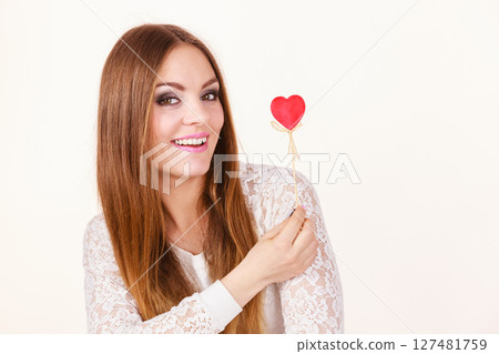 Beautiful woman holding heart shaped hand stick 127481759