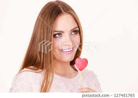 Beautiful woman holding heart shaped hand stick 127481765