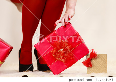 Female legs in red pantyhose and many gift boxes 127481961