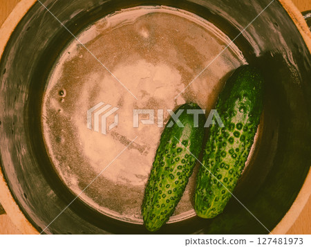 Making pickled cucumbers in clay jar Making pickled cucumbers in clay jar 127481973