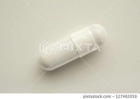White herbal medicine capsule on white background 127482059