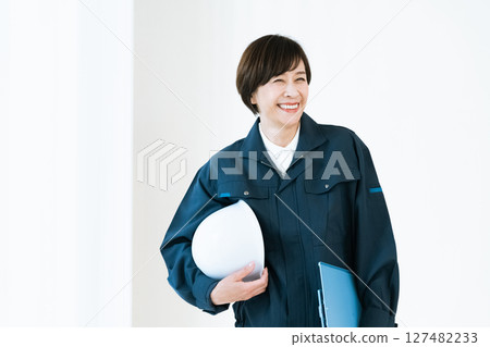 Middle-aged woman in work clothes Middle-aged woman in work clothes 127482233