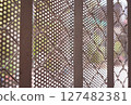 Close-up of a perforated metal fence 127482381