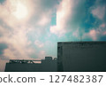 Rooftop silhouette under a vibrant sky with scattered clouds 127482387