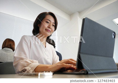 A woman who works with a smile A woman who works with a smile 127483403