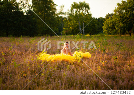 A Joyful Moment Captured in a Vibrant Yellow Tutu Surrounded by Beautiful Nature 127483452