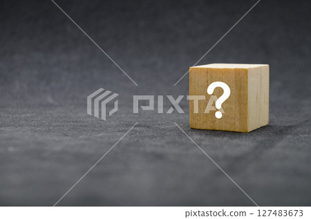 Single wooden cube with question mark on front, isolated on light background Single wooden cube with question mark on front, isolated on light background 127483673