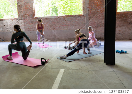 A Group of Women Engaged in Various Fitness Activities for Health and Wellbeing Goals 127483857