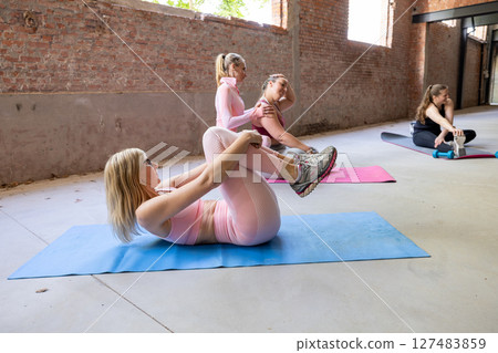 Join us for a revitalizing Group Workout Session held in a modern studio setting that inspires Join us for a revitalizing Group Workout Session held in a modern studio setting that inspires 127483859