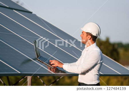 Man is doing operating and maintenance in solar power plant 127484139
