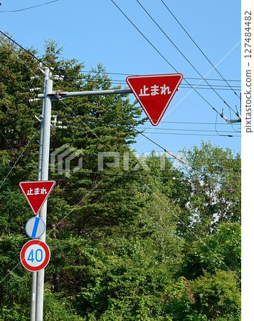 A stop sign at an intersection without traffic lights (vertical photo) 127484482