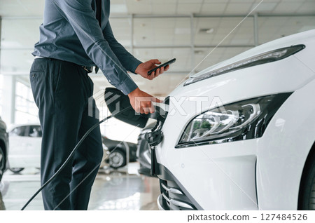 Close up view of man that is with electrical car 127484526