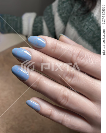 Nail extensions, manicure, nail correction, hands in the foreground gel polishes Nail extensions, manicure, nail correction, hands in the foreground gel polishes 127485093