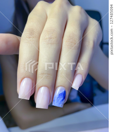 Nail extensions, manicure, nail correction, hands in the foreground gel polishes 127485094