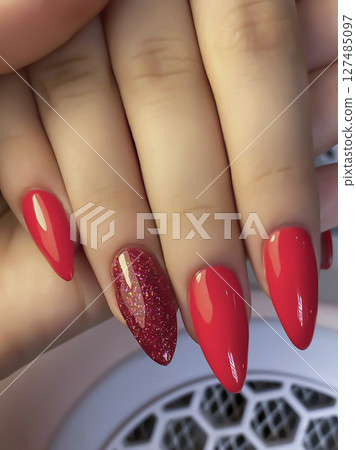 Nail extensions, manicure, nail correction, hands in the foreground gel polishes Nail extensions, manicure, nail correction, hands in the foreground gel polishes 127485097