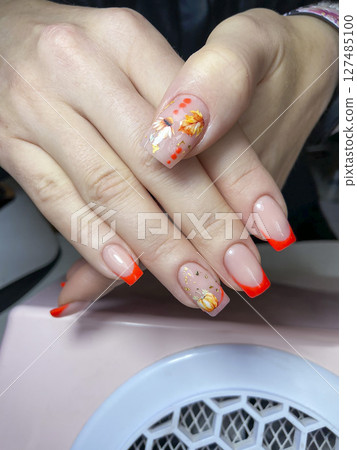 Nail extensions, manicure, nail correction, hands in the foreground gel polishes Nail extensions, manicure, nail correction, hands in the foreground gel polishes 127485100