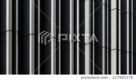 Modern brutalist building facade with strong vertical lines and abstract shadow pattern 127485278