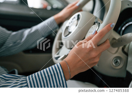 Driving the automobile. Close up view of woman that is with electric car Driving the automobile. Close up view of woman that is with electric car 127485388