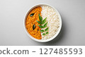 Traditional indian lentil dal and rice with curry leaves in a white bowl 127485593