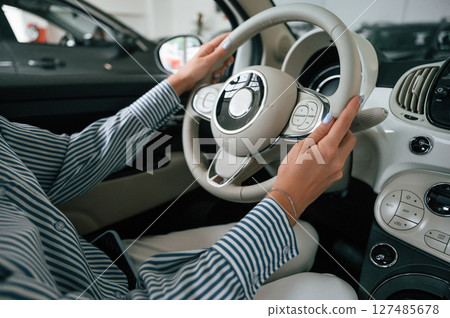 Driving the automobile. Close up view of woman that is with electric car Driving the automobile. Close up view of woman that is with electric car 127485678