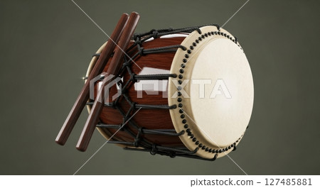 A traditional japanese taiko drum with wooden drumsticks on a plain background. 127485881