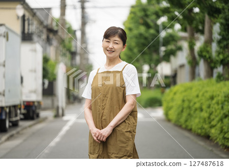 Portrait of a woman in her 50s wearing an apron 127487618