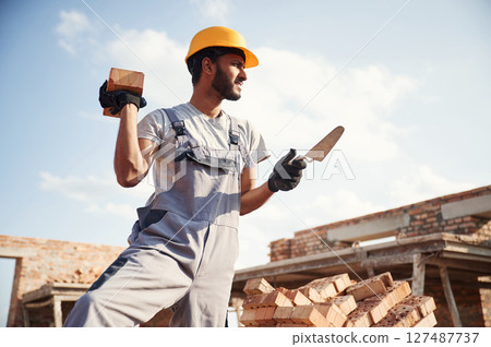 Outdoors at daytime. Handsome Indian man is on the construction site 127487737