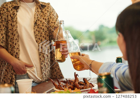 Close up view of two women that is with beer in hands Close up view of two women that is with beer in hands 127488253