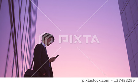 Pale pastel colored sunset and young man - Emotional scenery 127488299