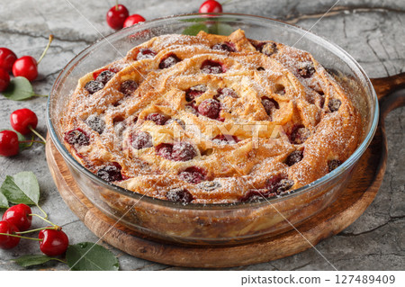 Sweet crispy filo pastry tart with cherries and custard close-up in glass bowl. horizontal 127489409