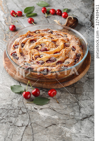 Berry filo pastry pie with cherries and custard close-up in a glass bowl. vertical Berry filo pastry pie with cherries and custard close-up in a glass bowl. vertical 127489411