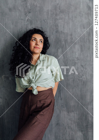 Portrait of a beautiful brunette woman in summer clothes Portrait of a beautiful brunette woman in summer clothes 127489713