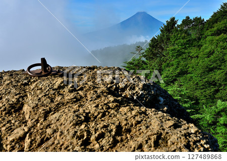 A view of cloud-covered summer Mt. Fuji from a rocky observation deck in the Misaka Mountains A view of cloud-covered summer Mt. Fuji from a rocky observation deck in the Misaka Mountains 127489868