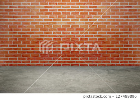 An empty room with red brick walls. The red brick walls create a warm atmosphere. 127489896