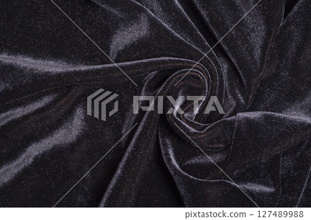 Black velvet fabric with spiral folds 127489988
