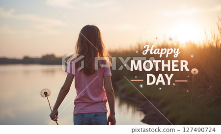 Mother's Day Sunset: A Young Girl's Gift of a Dandelion by the Lakeside 127490724