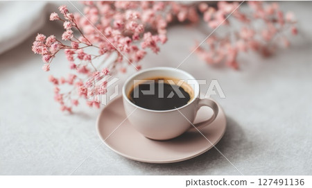 Ceramic Coffee Cup on Table with Pink Decorative Flowers 127491136