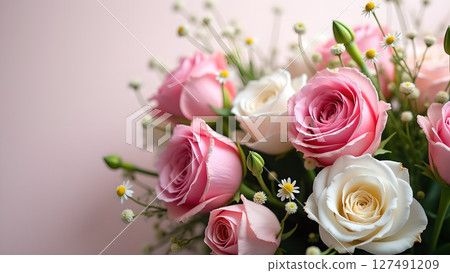 Elegant bouquet of pink and white roses with delicate daisies on a soft backdrop 127491209