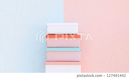 stacked package boxes in various colors and patterns, against pastel colored background stacked package boxes in various colors and patterns, against pastel colored background 127491442