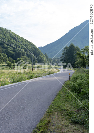 A country road leading to the mountains of Minamiaizu 127492976
