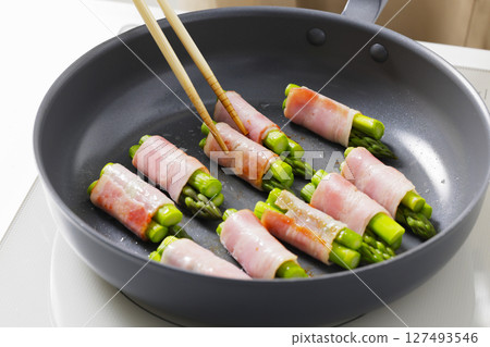 A scene of cooking asparagus bacon in the kitchen 127493546