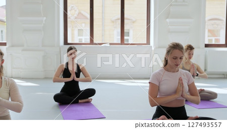Yoga class, meditation instructor, breathing exercise. Freedom, calm and people learning yoga, training. 127493557