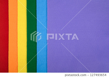 Felt samples in rainbow colors in a vertical arrangement. There is space for text. 127493654