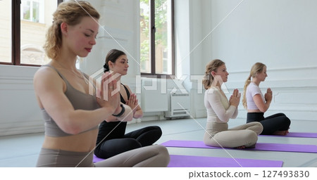 Yoga class, meditation instructor, breathing exercise. Freedom, calm and people learning yoga, training. Yoga class, meditation instructor, breathing exercise. Freedom, calm and people learning yoga, training. 127493830