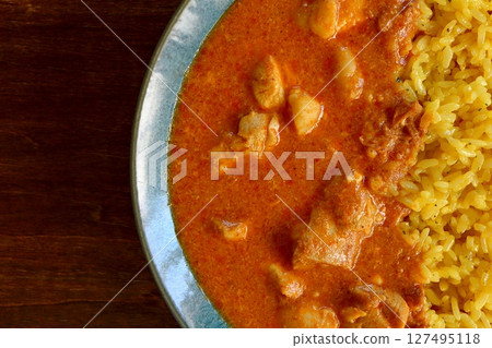 Butter chicken curry on table background viewed from above Butter chicken curry on table background viewed from above 127495118