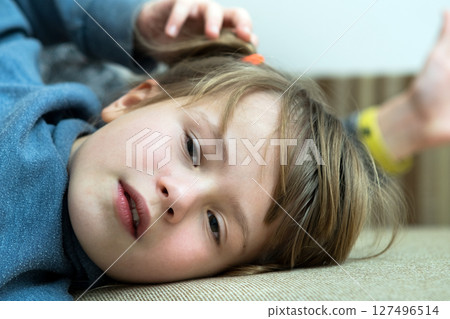 Portrait of a pretty child girl laying down at home. 127496514